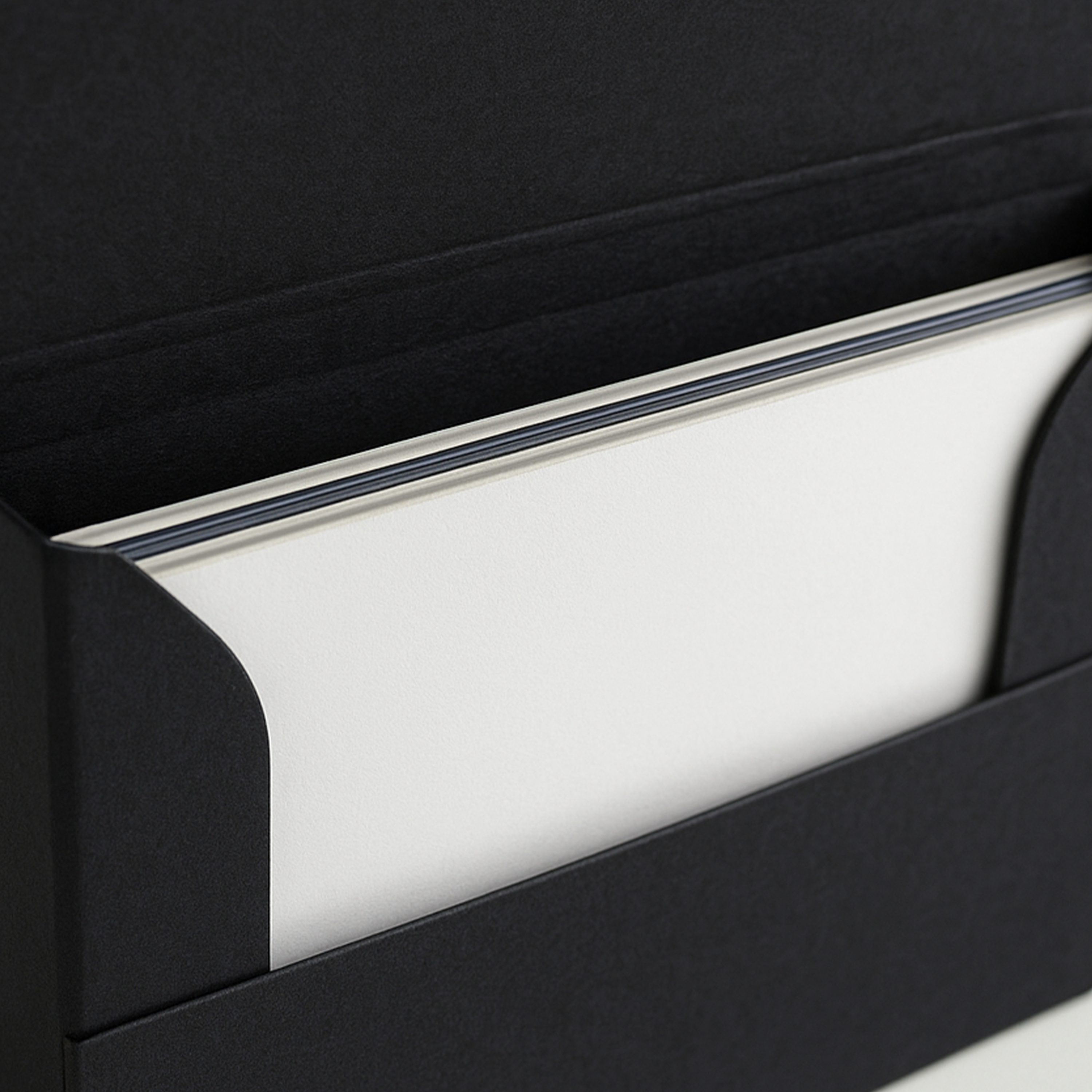 Detailed close-up of a PullShield protective sleeve with white cardboard inserts and the edge of a trading card in a top loader.