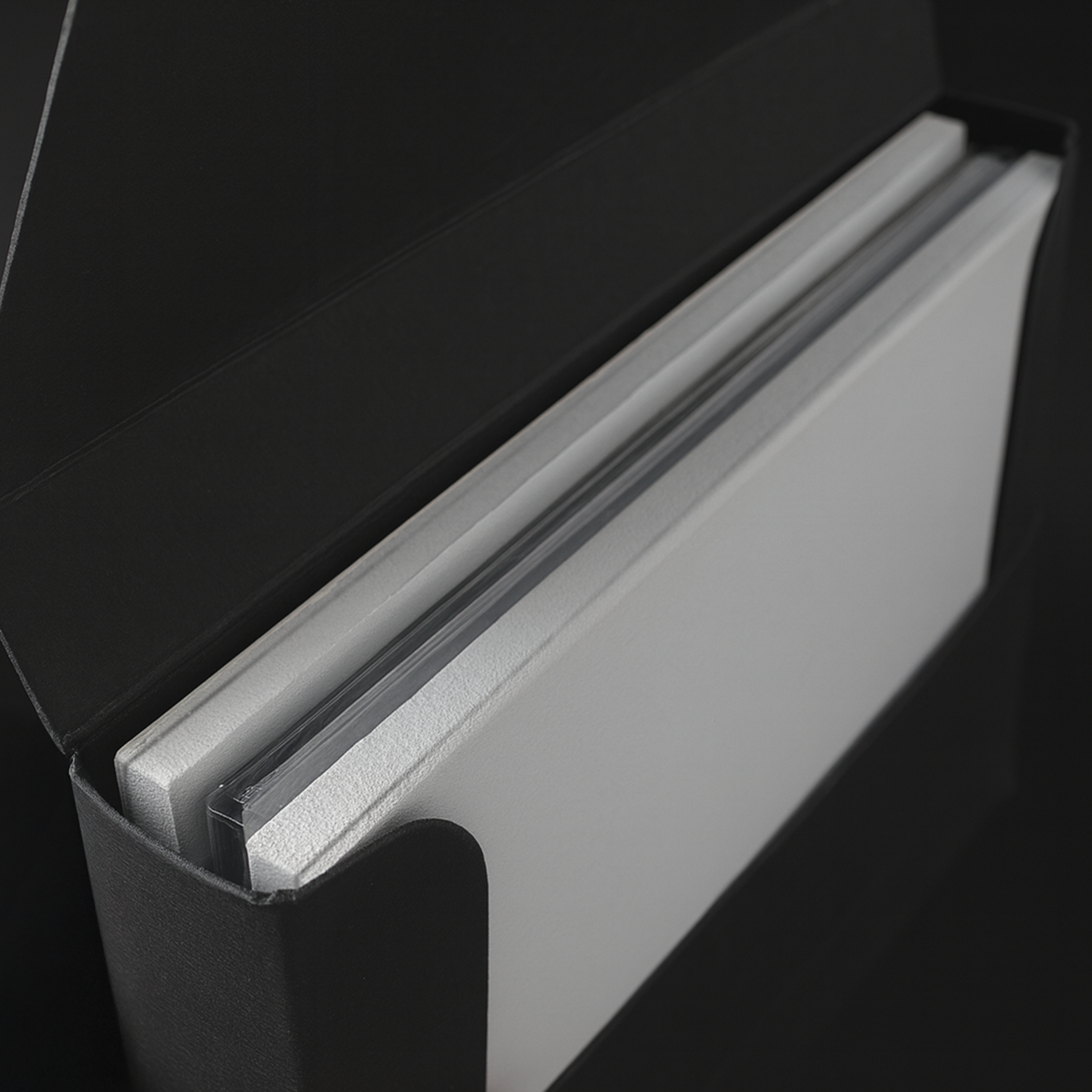 Graded trading card slab securely stored in a PullShield sleeve with white foam board inserts for added protection.